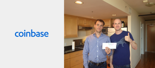 Two people standing in the kitchen with an envelope in their hands and a thumbs up